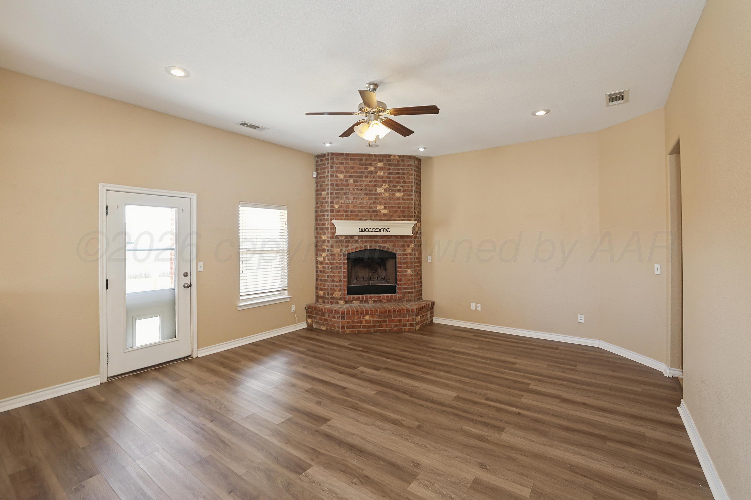 19101 Sundancer Lane Bushland, TX 79124 - Photo 6 of 25 a view of an empty room with a window and wooden floor
