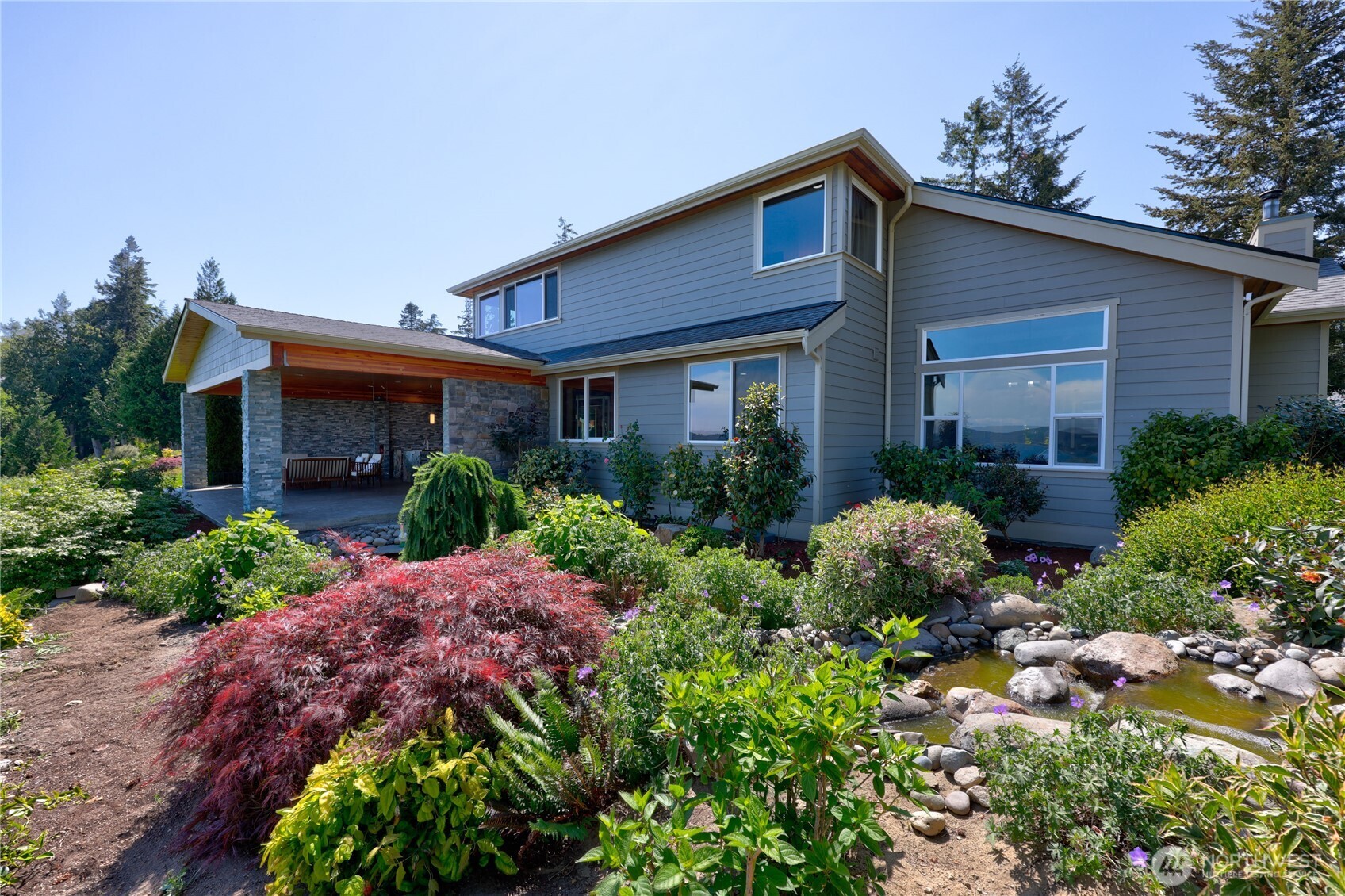 1411 Thorndyke Road Port Ludlow, WA 98365 - Photo 2 of 40 a front view of house with a lot of flower plants