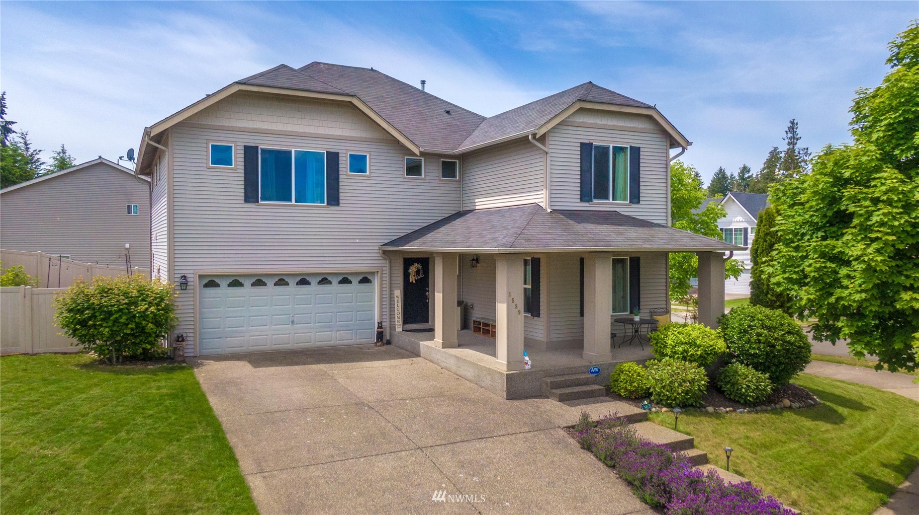 1589 Grant Avenue DuPont, WA 98327 - Photo 1 of 30 a front view of a house with a garden