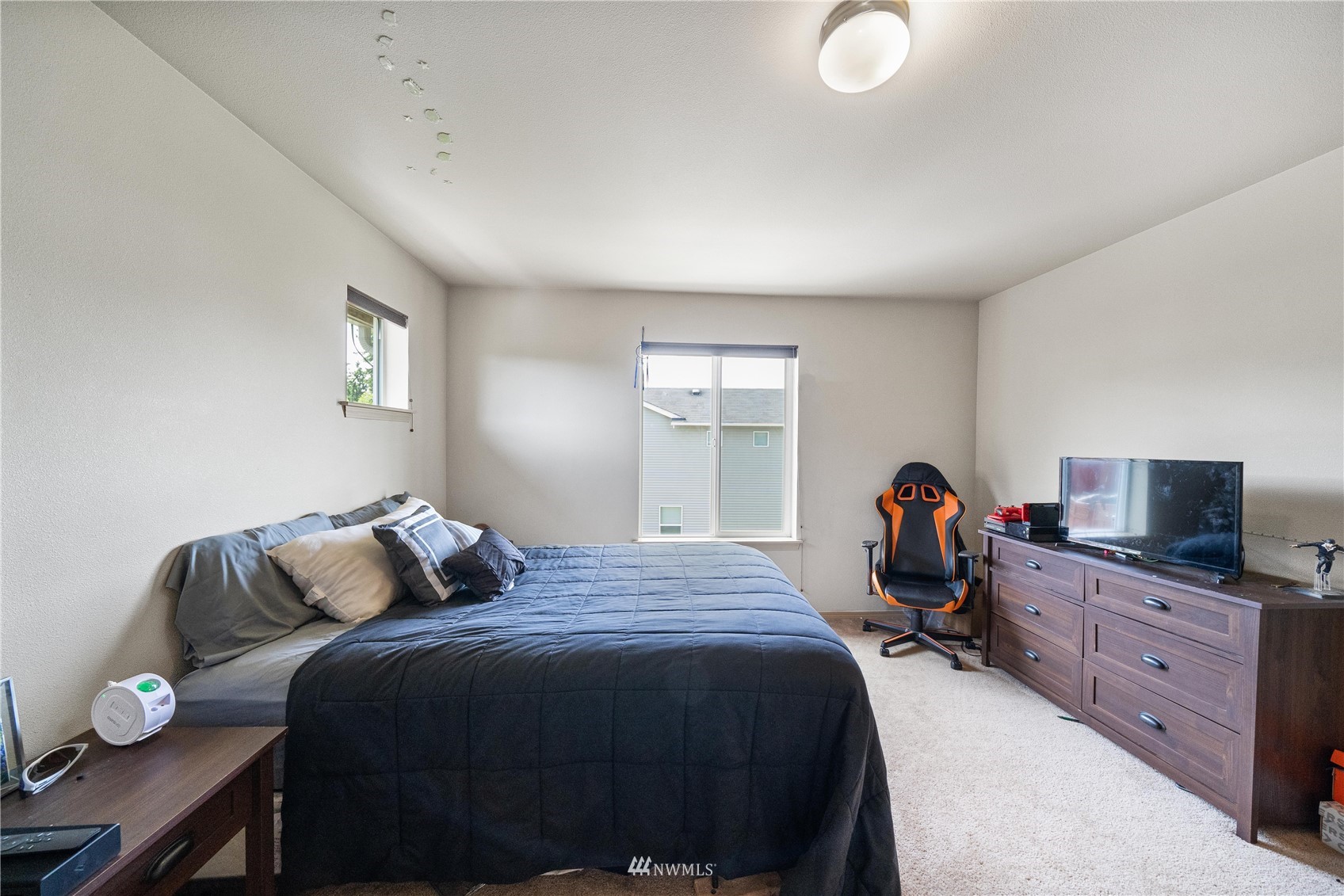 1589 Grant Avenue DuPont, WA 98327 - Photo 17 of 30 a bedroom with a bed and wooden floor