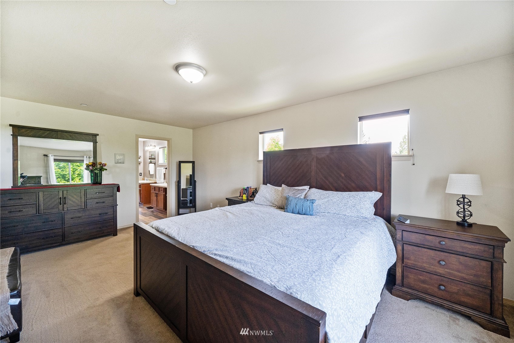 1589 Grant Avenue DuPont, WA 98327 - Photo 21 of 30 a large bedroom with a bed and wooden floor