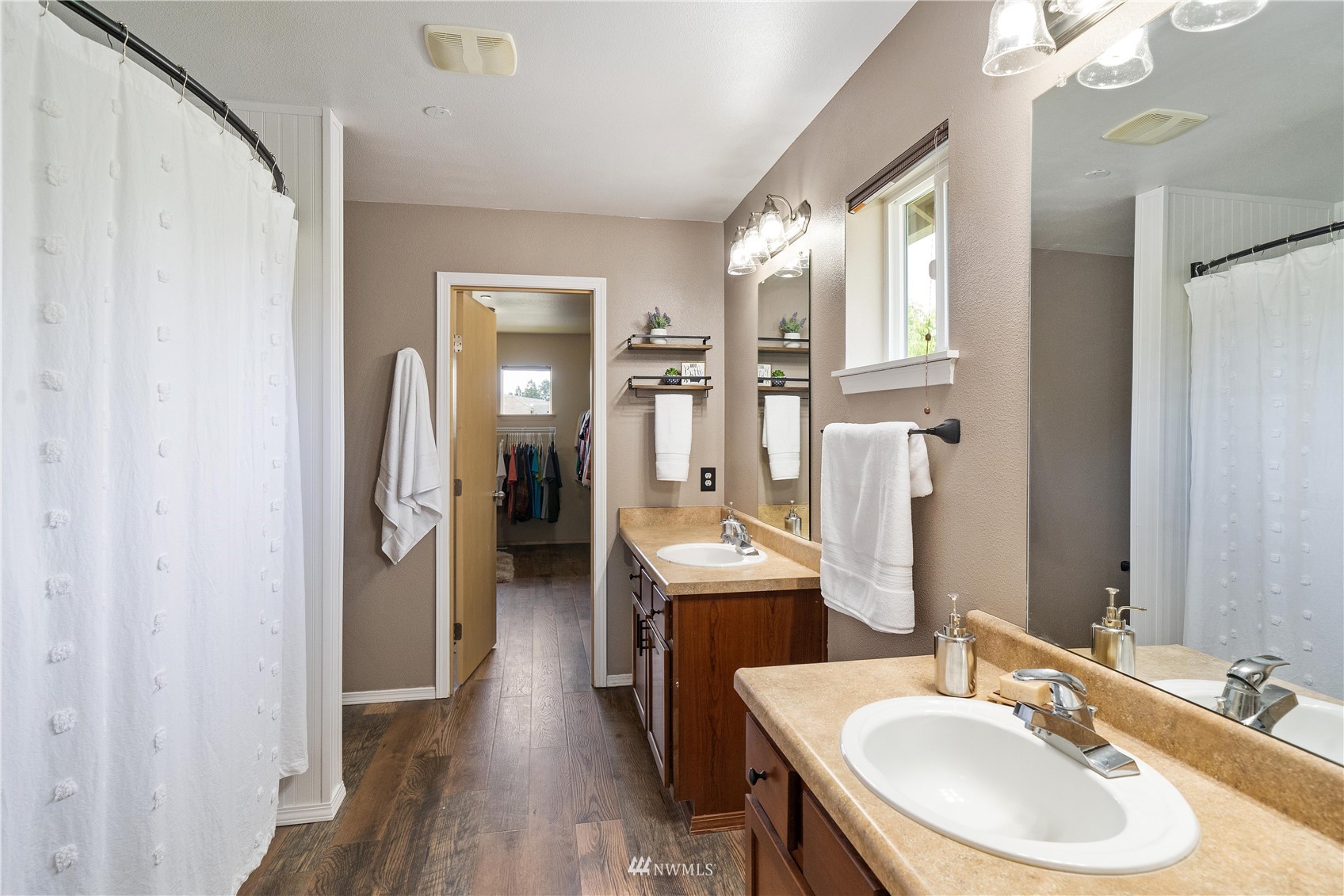 1589 Grant Avenue DuPont, WA 98327 - Photo 22 of 30 a en suite bathroom with a double vanity sink a mirror and a shower