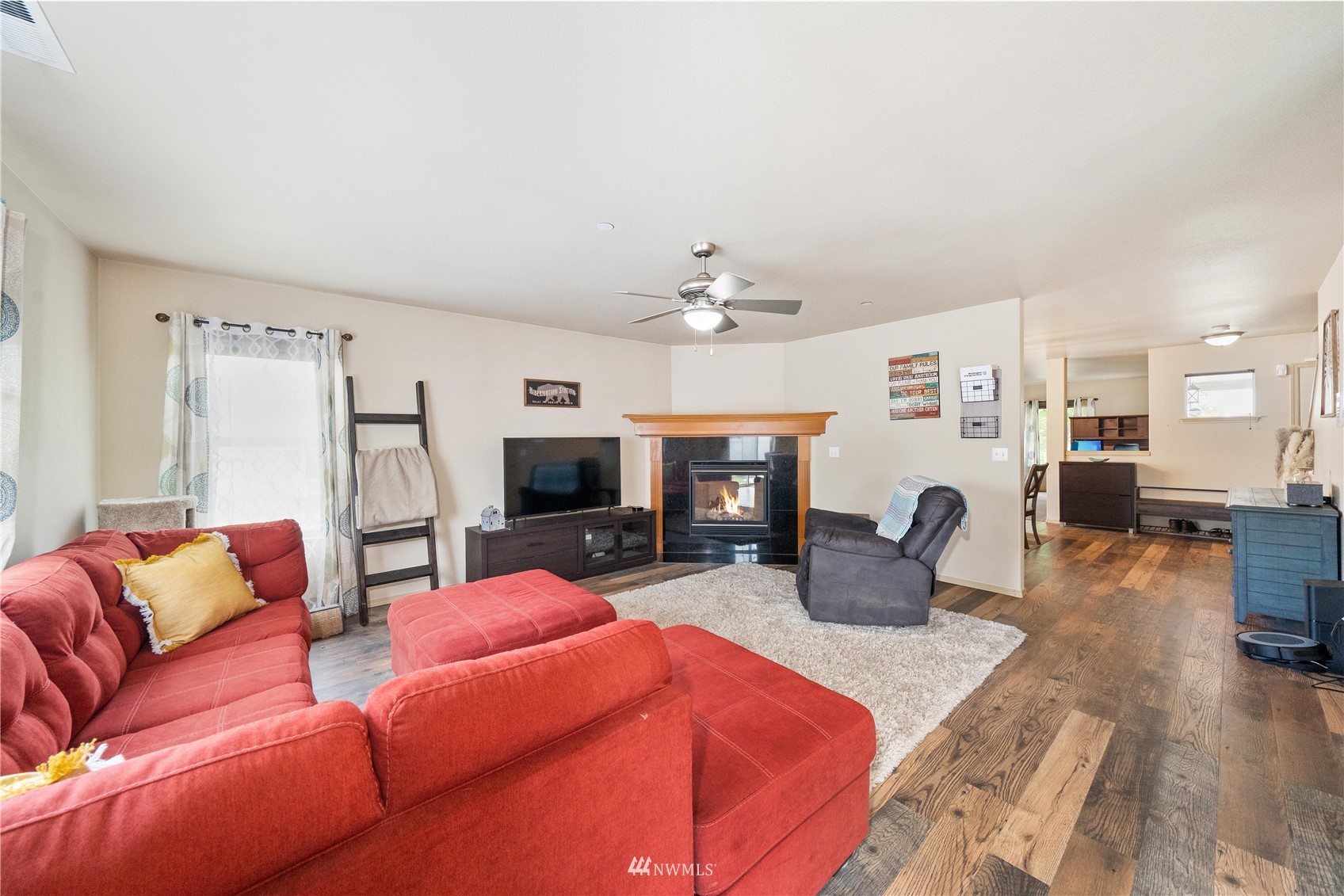 1589 Grant Avenue DuPont, WA 98327 - Photo 5 of 30 a living room with furniture a flat screen tv and kitchen view