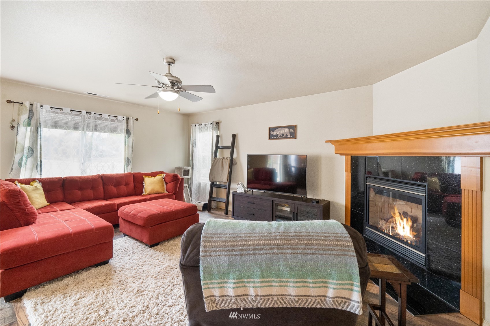 1589 Grant Avenue DuPont, WA 98327 - Photo 6 of 30 a bedroom with furniture a flat screen tv and a fireplace