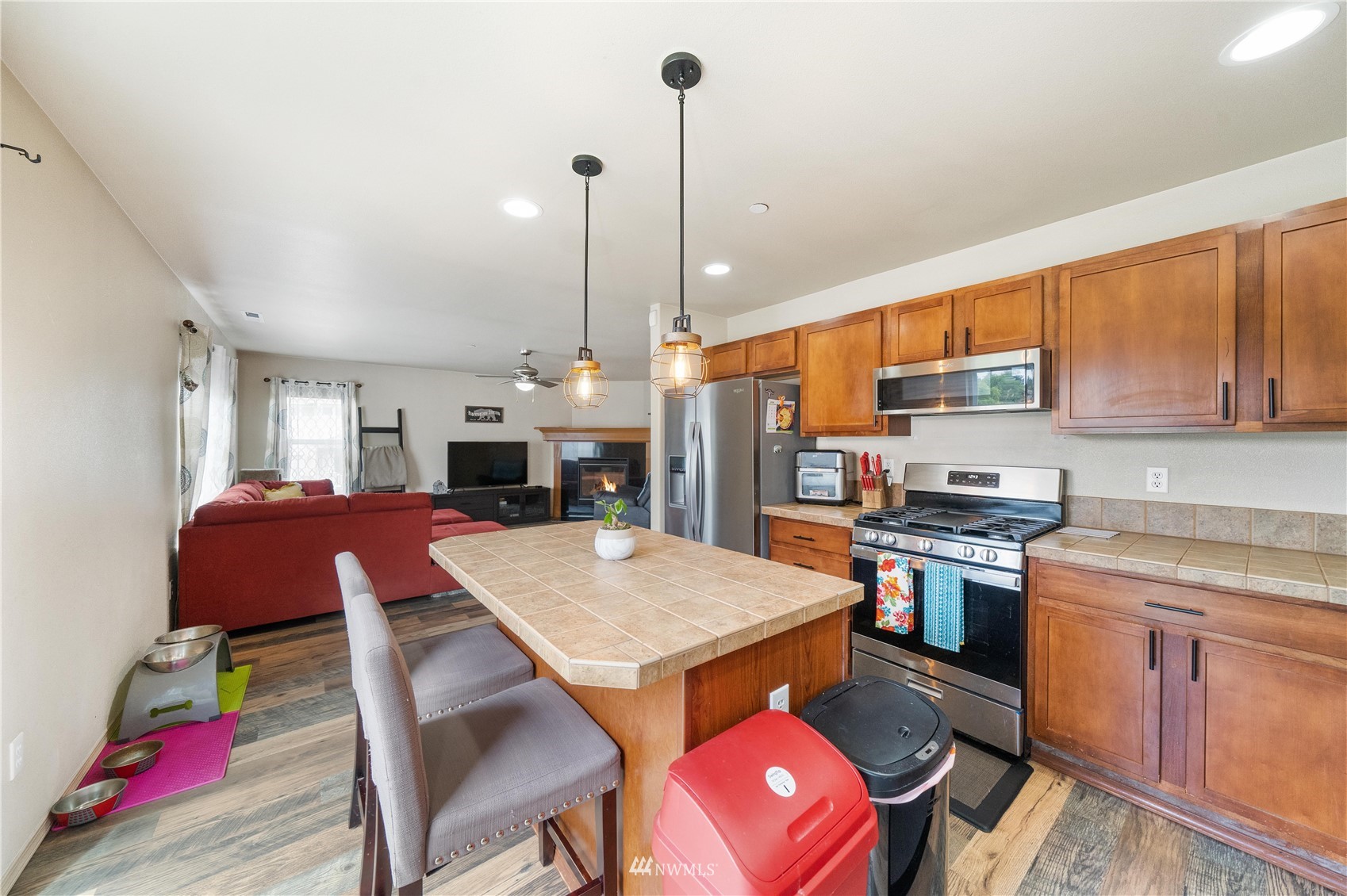 1589 Grant Avenue DuPont, WA 98327 - Photo 8 of 30 a open kitchen with stainless steel appliances granite countertop a dining table chairs and a refrigerator