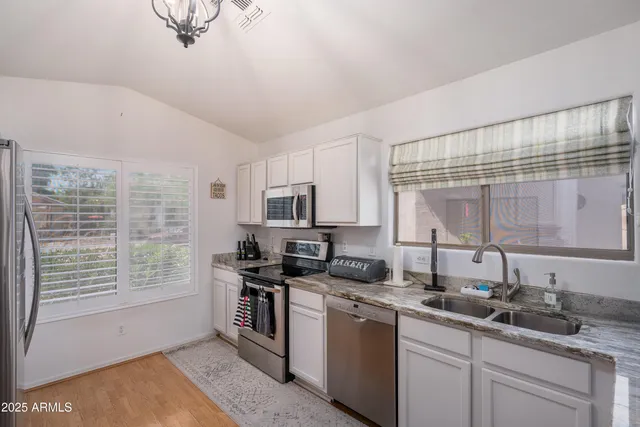 a kitchen with a sink stove and microwave
