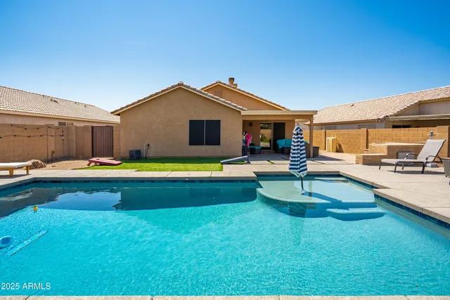 a view of a swimming pool with a lounge chairs