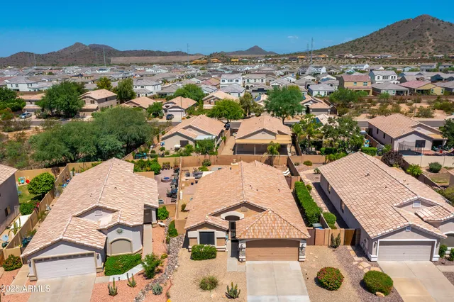 an aerial view of residential houses with outdoor space