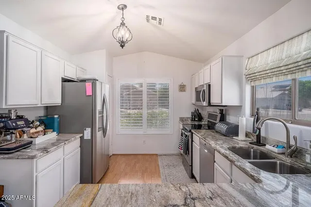 a kitchen with a sink stove and refrigerator