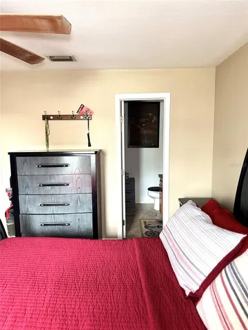 a bed room with a bed and a television