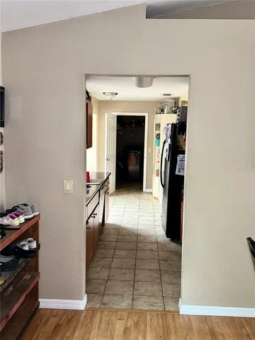 a view of a hallway with wooden floor and furniture