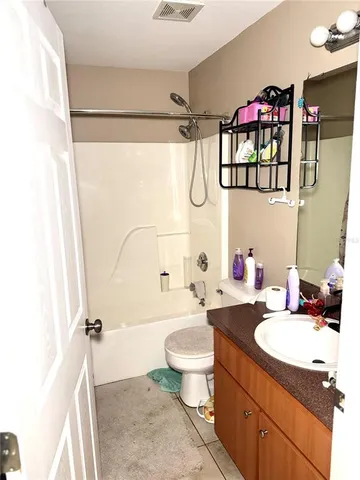 a bathroom with a sink mirror vanity and toilet