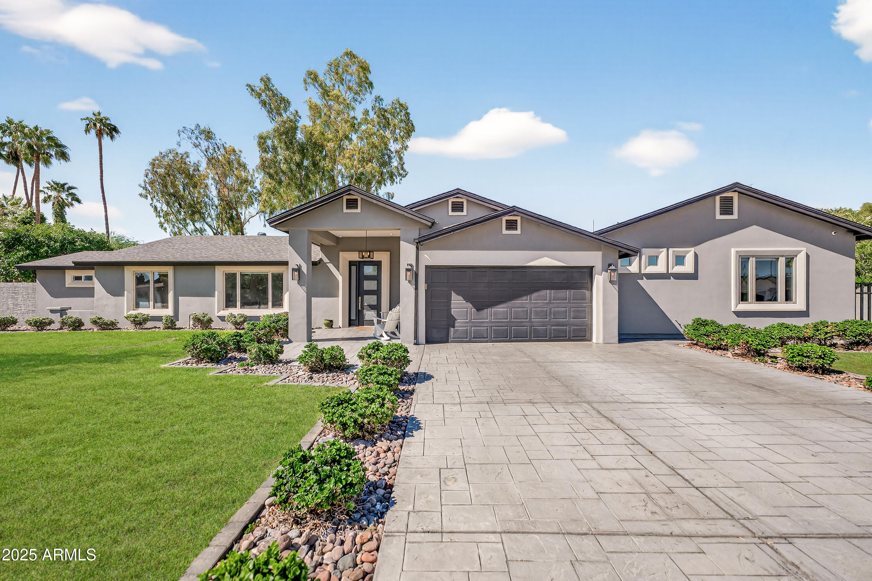 a front view of a house with a garden and yard