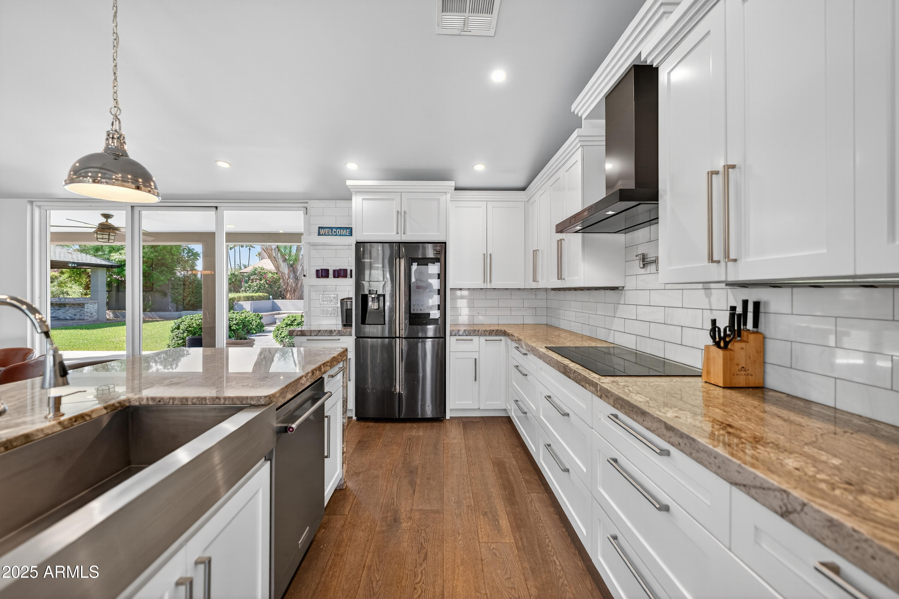 11026 North 42nd Street Phoenix, AZ 85028 - Photo 12 of 43 a kitchen with stainless steel appliances granite countertop sink stove refrigerator and cabinets