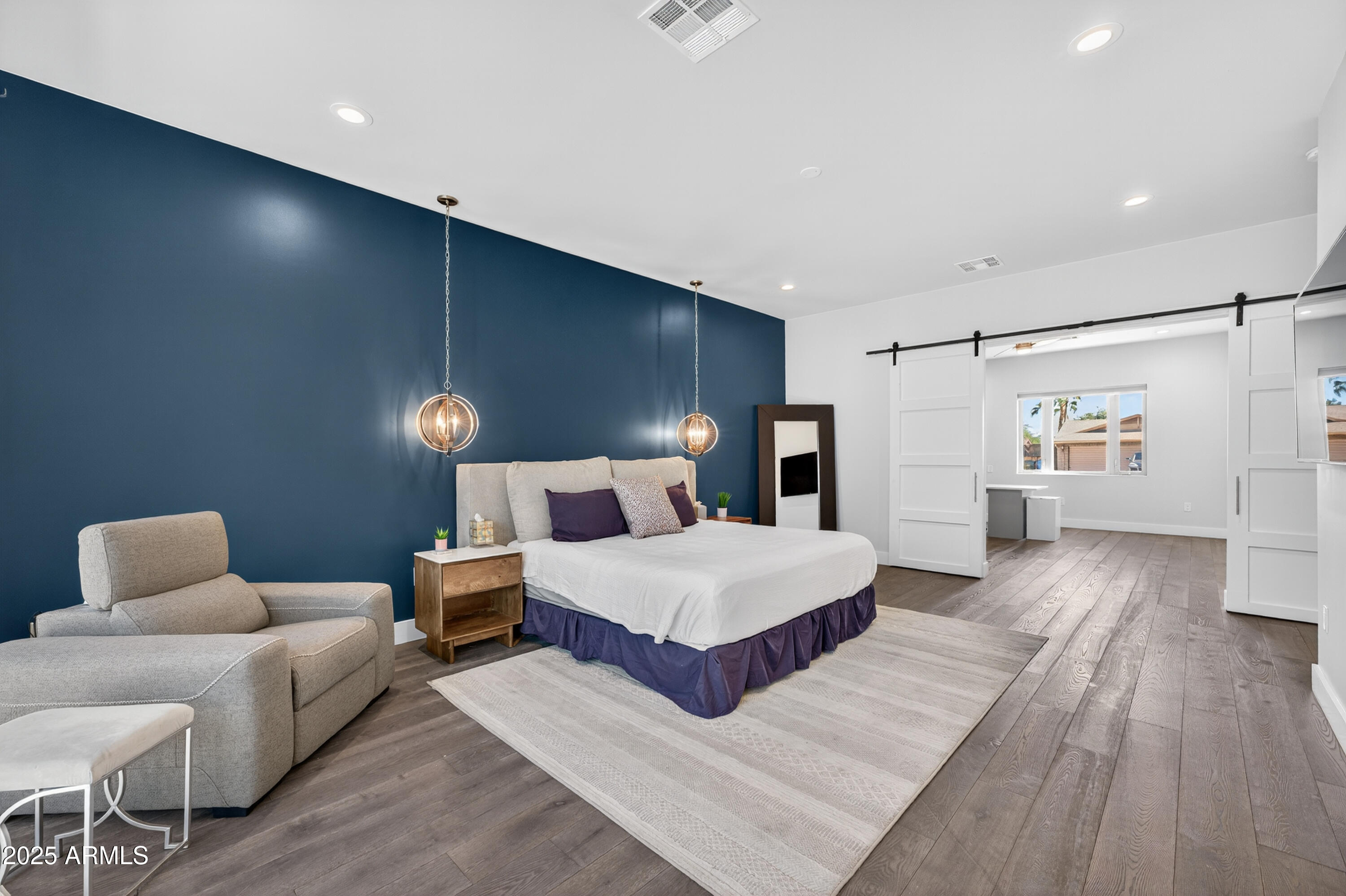 11026 North 42nd Street Phoenix, AZ 85028 - Photo 18 of 43 a spacious bedroom with a bed and a couch