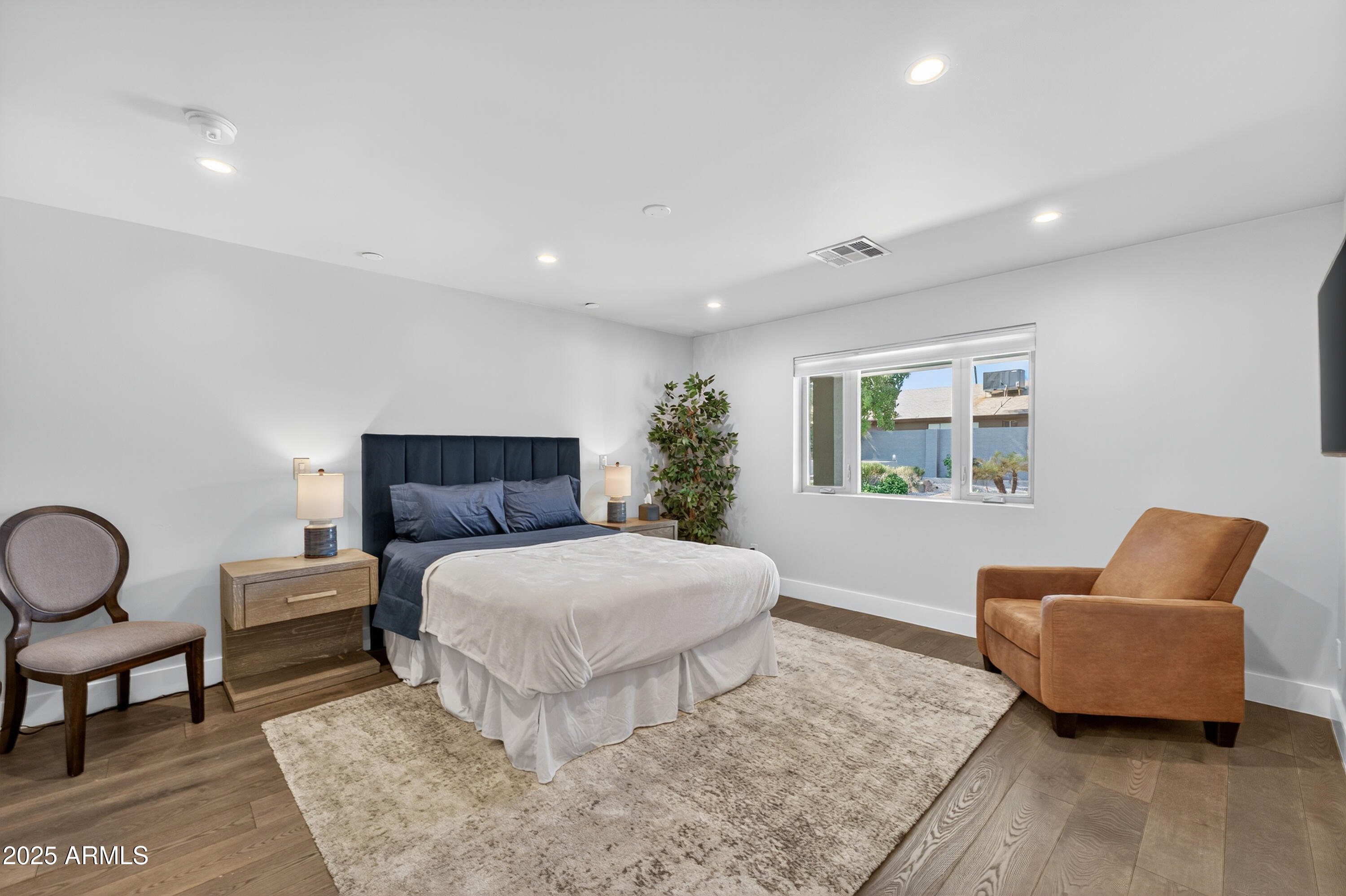 11026 North 42nd Street Phoenix, AZ 85028 - Photo 25 of 43 a bedroom with a bed and wooden floor