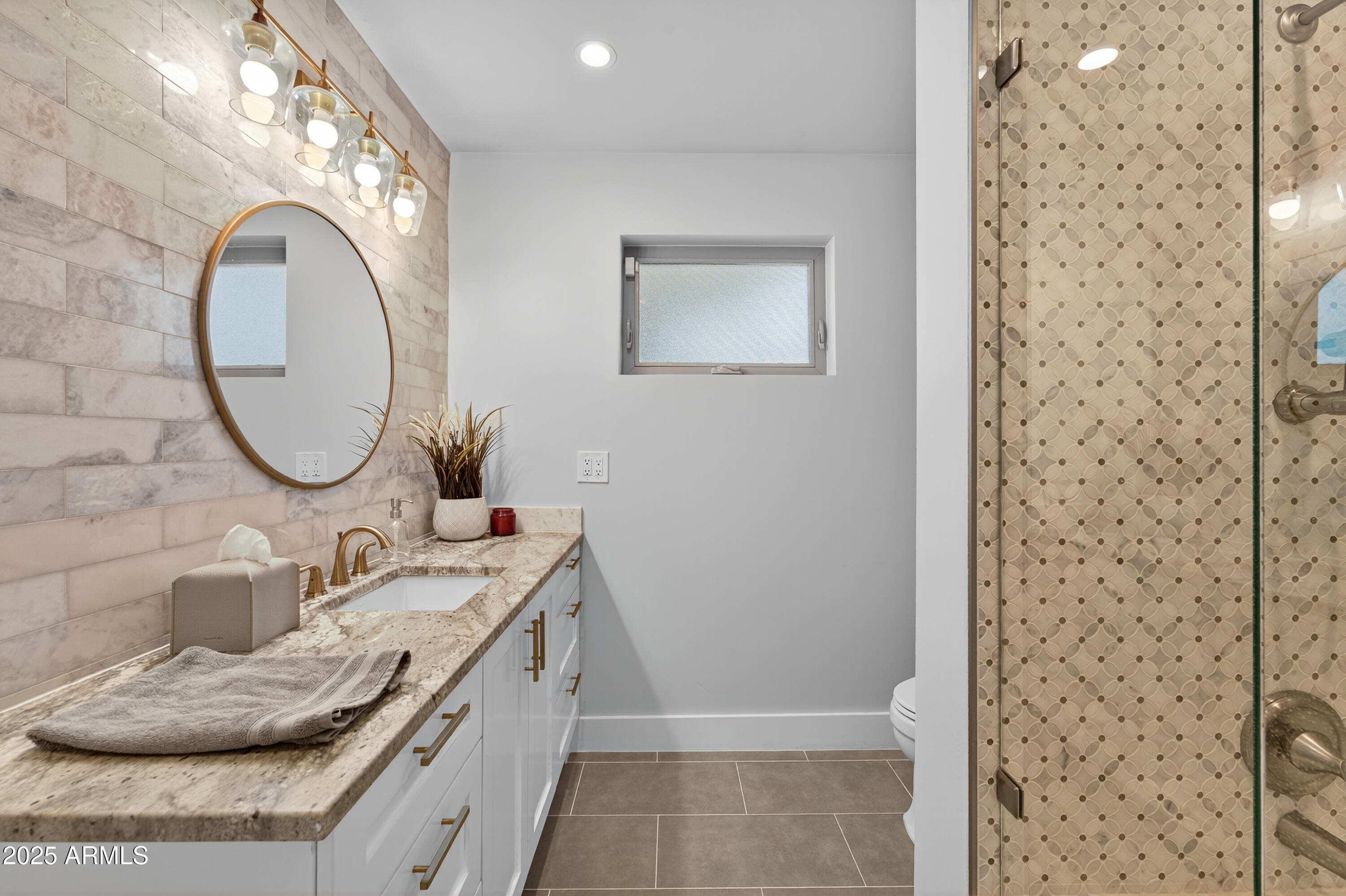 11026 North 42nd Street Phoenix, AZ 85028 - Photo 26 of 43 a bathroom with a granite countertop sink a mirror and a shower