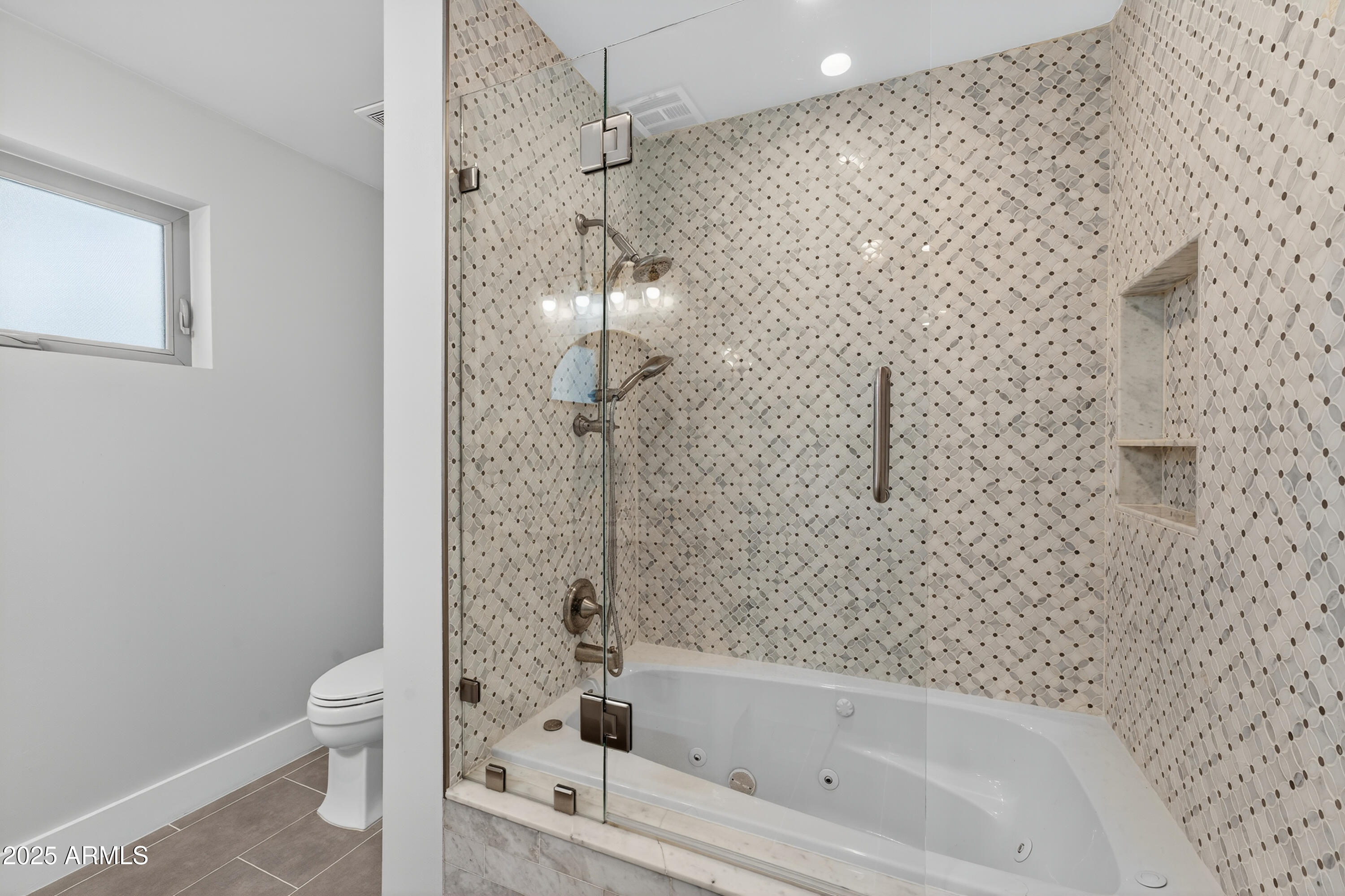 11026 North 42nd Street Phoenix, AZ 85028 - Photo 27 of 43 a bathroom with a bathtub and a toilet