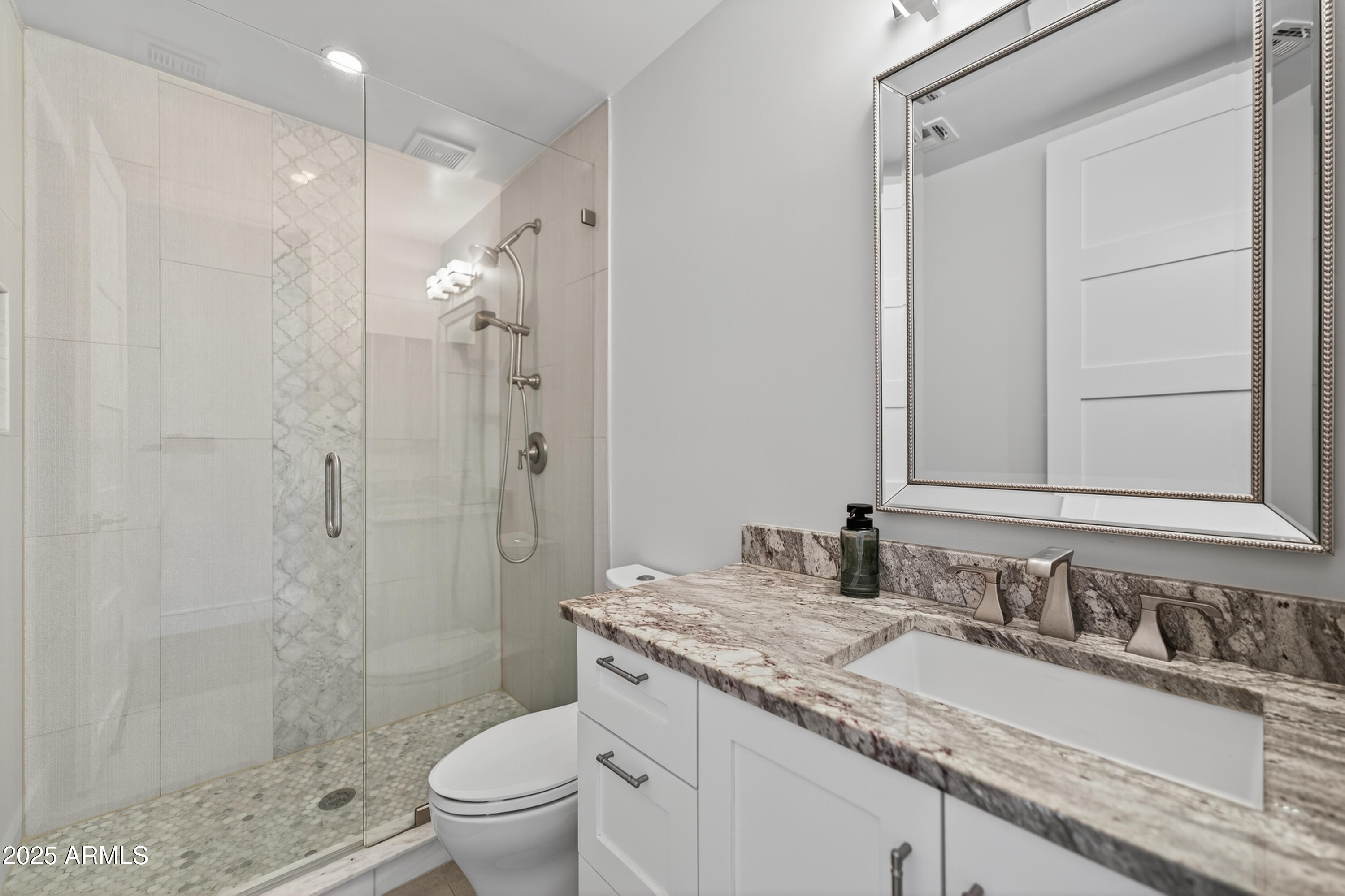 11026 North 42nd Street Phoenix, AZ 85028 - Photo 30 of 43 a bathroom with a granite countertop sink a toilet a shower and a mirror