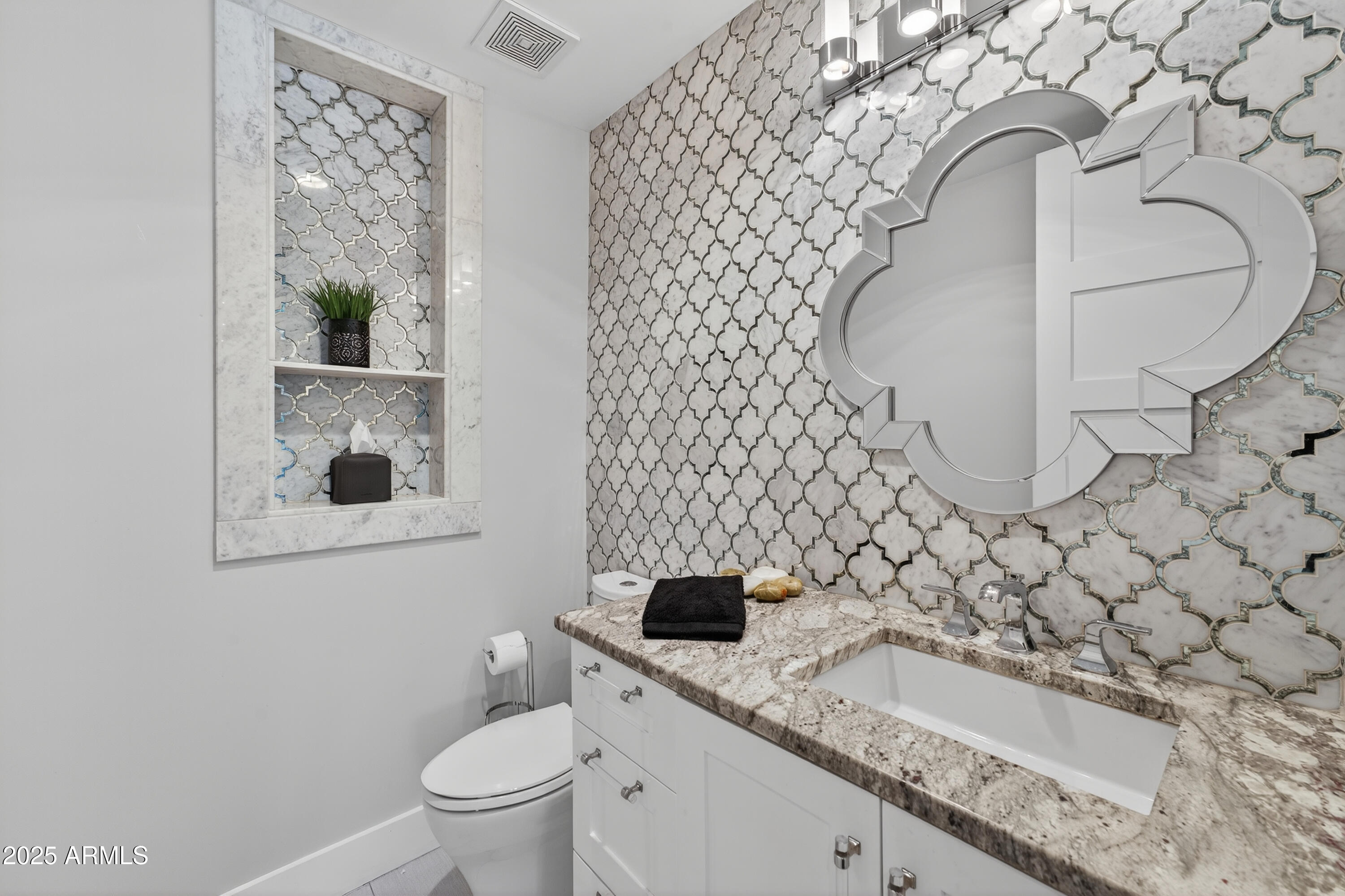 11026 North 42nd Street Phoenix, AZ 85028 - Photo 35 of 43 a bathroom with a sink a toilet and a mirror