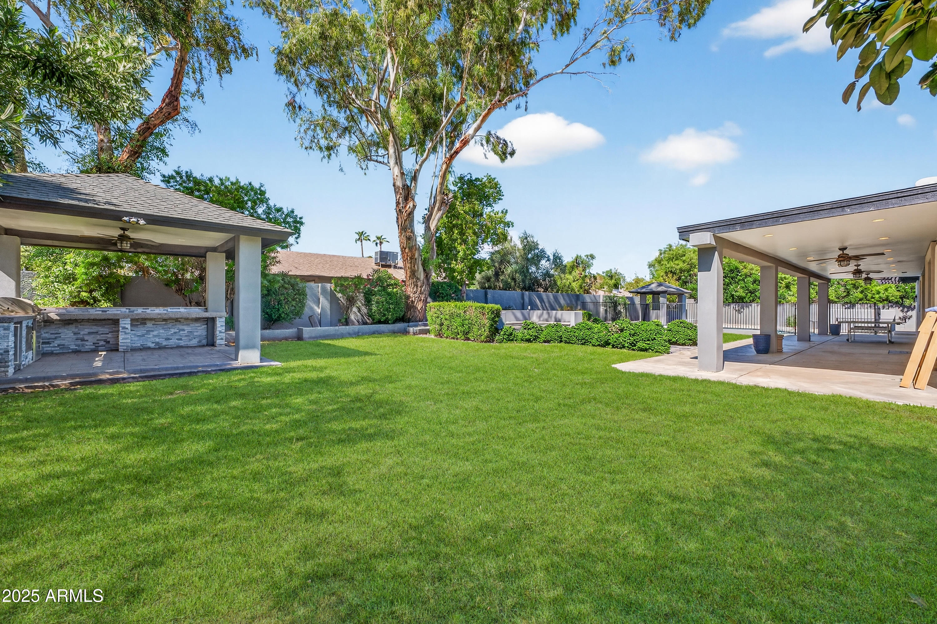 11026 North 42nd Street Phoenix, AZ 85028 - Photo 38 of 43 a view of a house with a backyard porch and sitting area