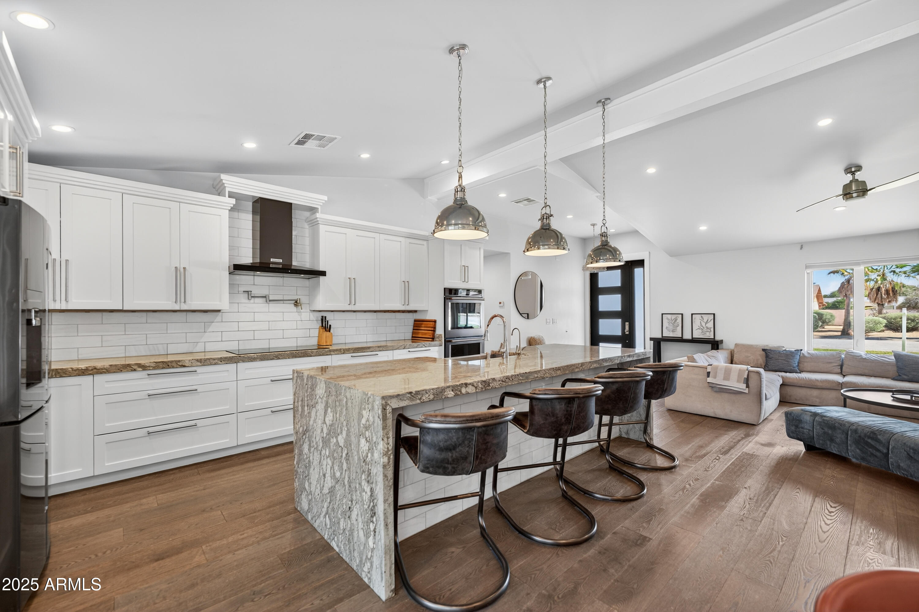 11026 North 42nd Street Phoenix, AZ 85028 - Photo 9 of 43 a open kitchen with stainless steel appliances granite countertop a stove a sink dishwasher a dining table and chairs with wooden floor