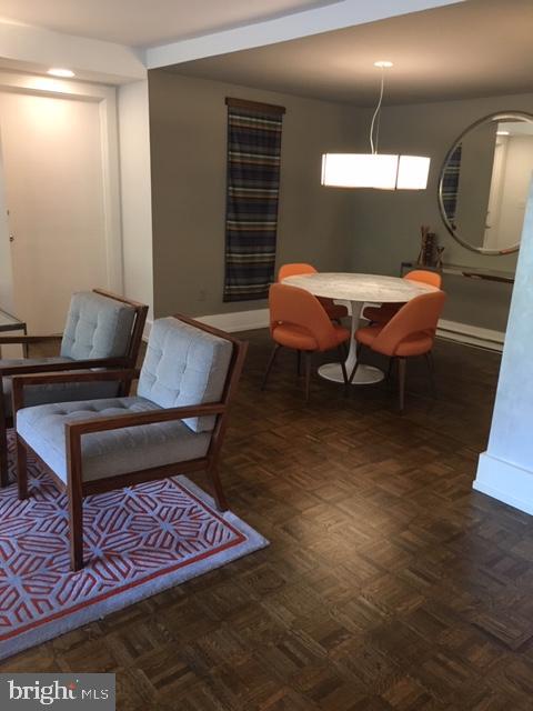 4000 Tunlaw Road Northwest, Unit 414 Washington, DC 20007 - Photo 10 of 14 a living room with furniture and wooden floor