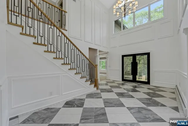 a view of staircase with white walls and a black white checkered floor
