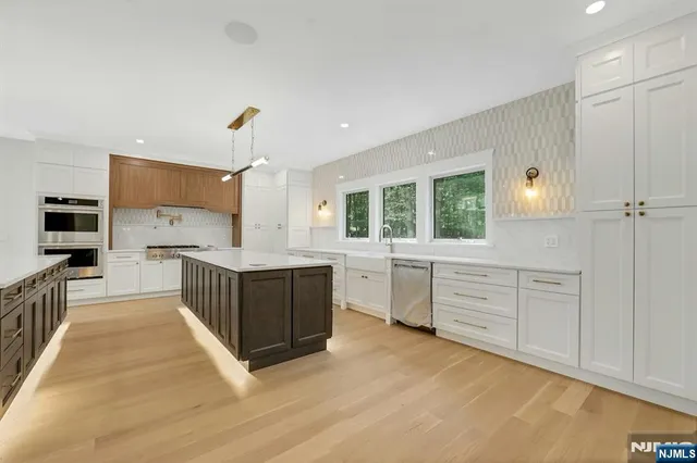 a stove top oven sitting inside of a kitchen