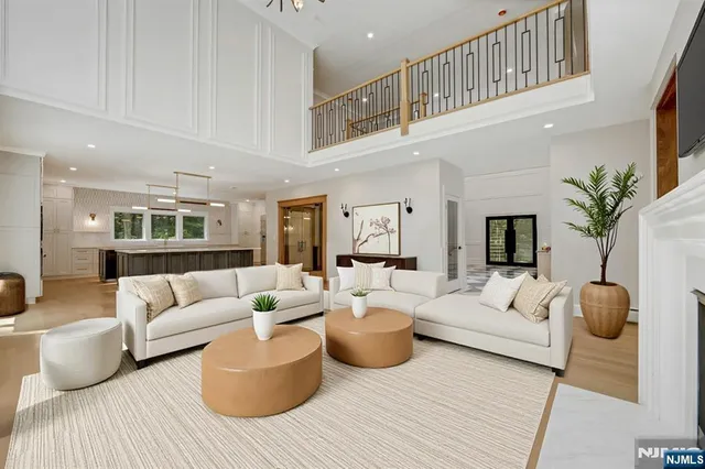 a living room with furniture a rug and a chandelier