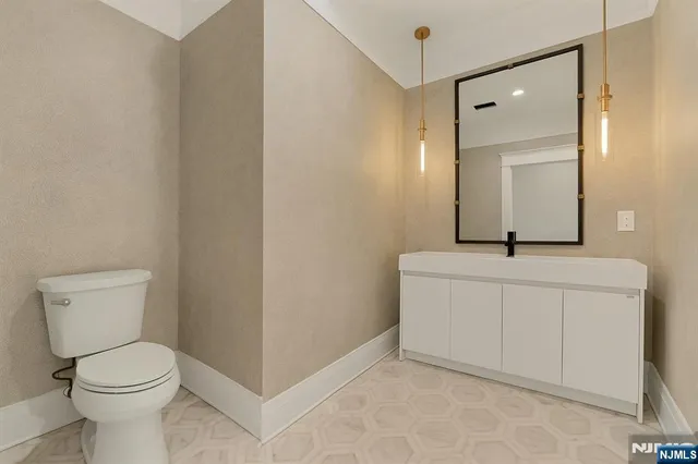 a view of a hallway to a livingroom with furniture