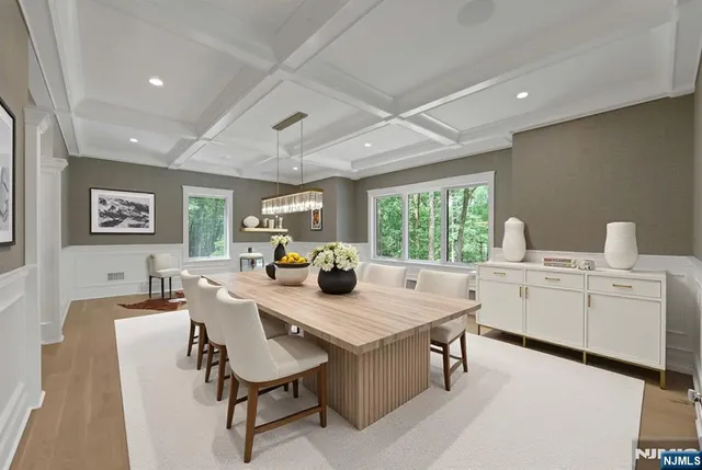 a kitchen with a stove a table and chairs in it