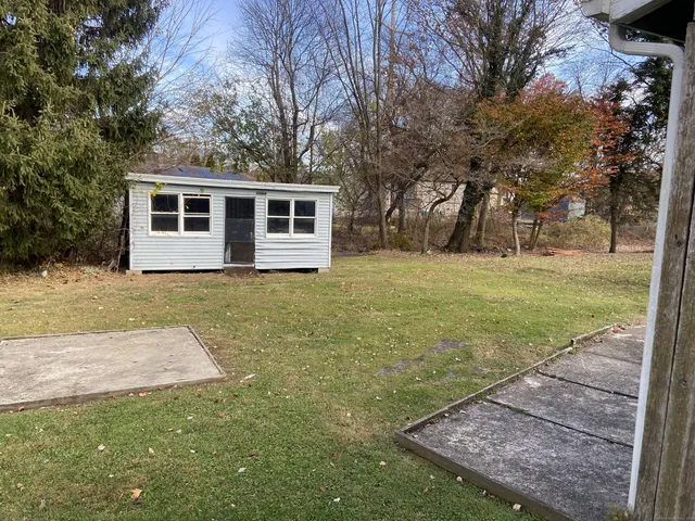 a view of a backyard with large trees