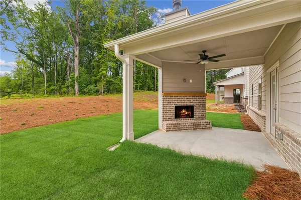 a view of a house with a yard and a fireplace
