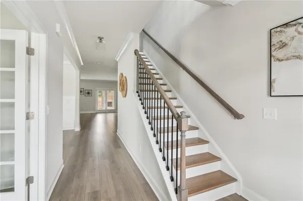a view of a hallway with wooden floor and entryway