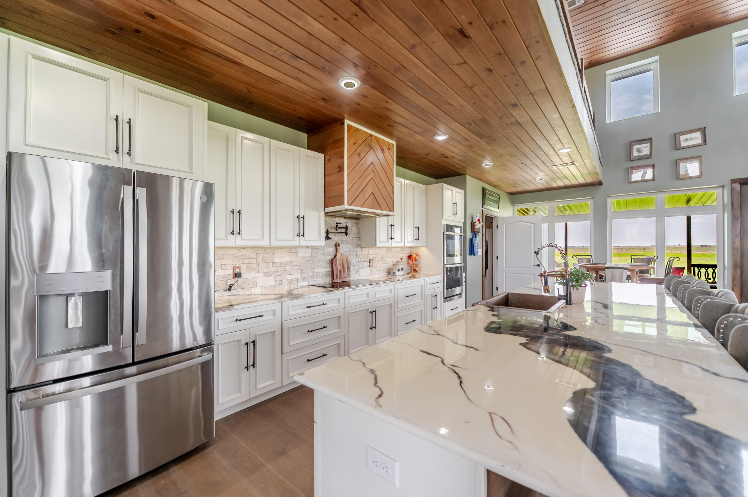 6792 Maine Road Anton, TX 79313 - Photo 10 of 77 a kitchen with stainless steel appliances kitchen island granite countertop a refrigerator and cabinets