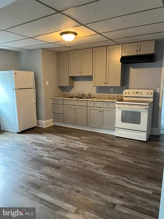 a kitchen with granite countertop a stove and a refrigerator