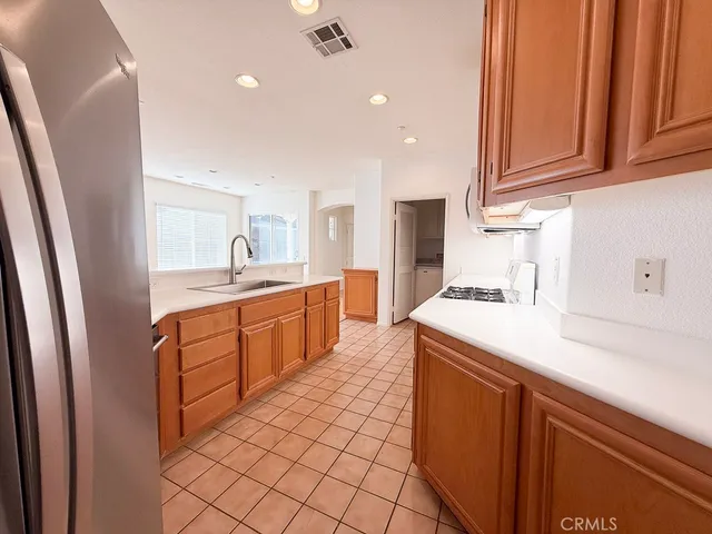 a kitchen with a sink window and cabinets
