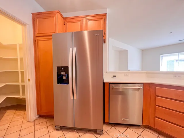a kitchen with stainless steel appliances granite countertop a refrigerator and a stove