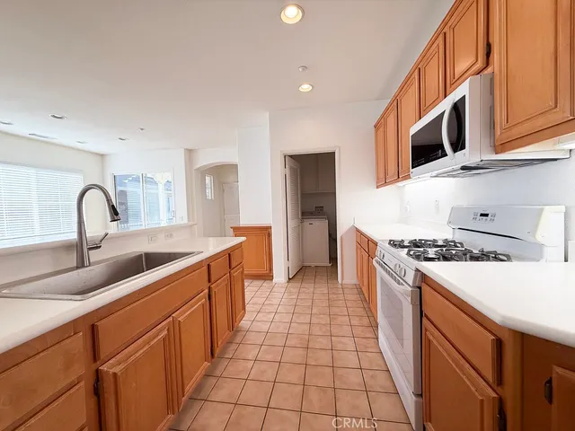 a large kitchen with stainless steel appliances granite countertop a stove and a sink