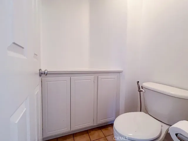 a white toilet sitting next to a bathroom sink