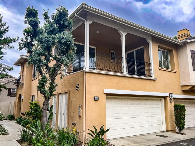 a front view of a house with plants