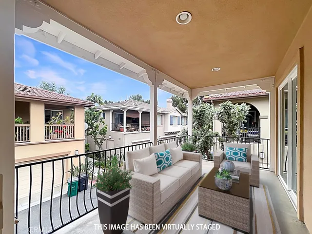 a view of a patio with couches plants and wooden floor