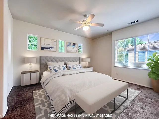 a bedroom with a large bed and a window