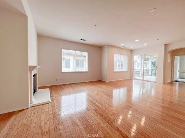 a view of a room with wooden floor and window