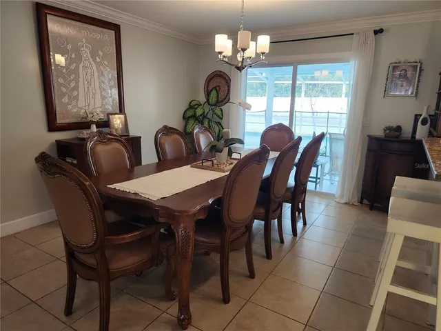 a view of a dining room with furniture and chandelier