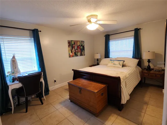 a bed room with a bed and a chair