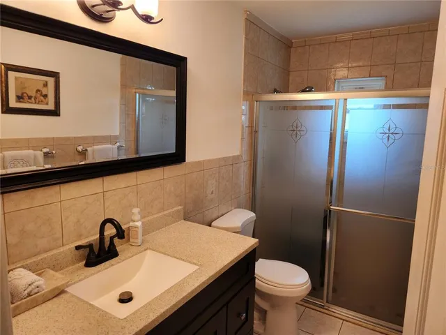 a bathroom with a sink a toilet and mirror