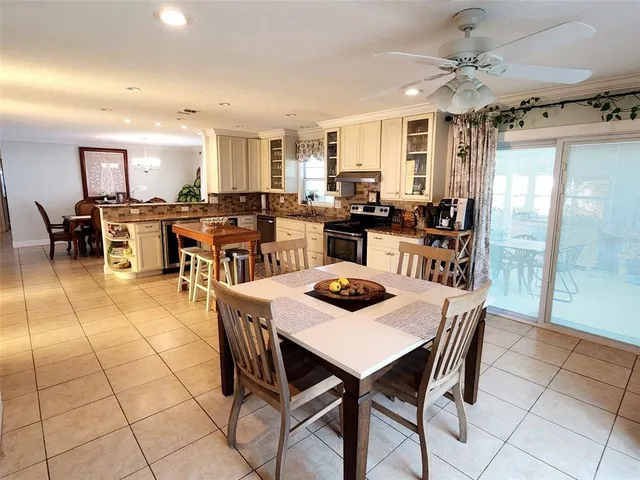 a view of a dining room with furniture and a chandelier