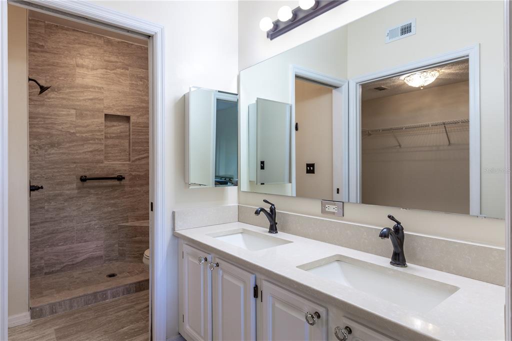 10000 Southwest 52nd Avenue, Unit 124 Gainesville, FL 32608 - Photo 14 of 33 a bathroom with a double vanity sink and a mirror